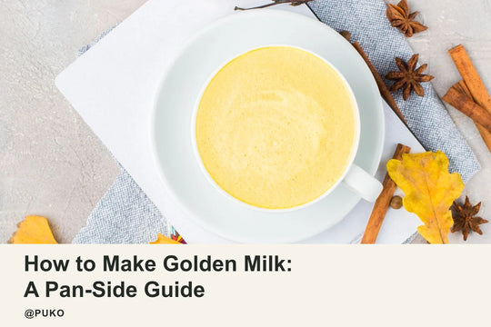 Golden turmeric latte in a white ceramic cup with decorative spices; How to Make Golden Milk: A Pan-Side Guide; @PUKO. Licensed stock, not a PUKO cooking test.