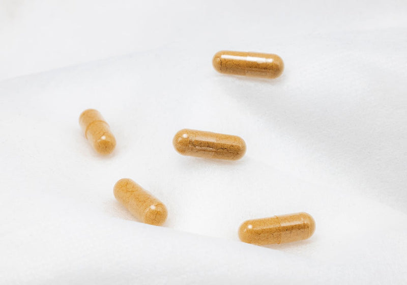 Supplement capsules on a white surface — magnesium glycinate 400 mg dosage explained