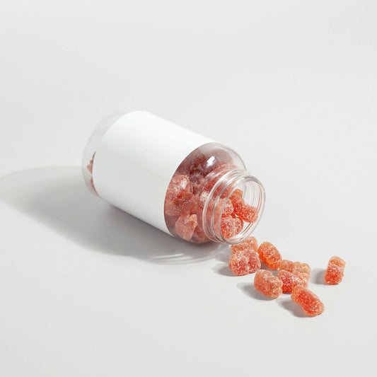 Supplement gummies on a white surface — magnesium glycinate gummies vs powder vs capsules