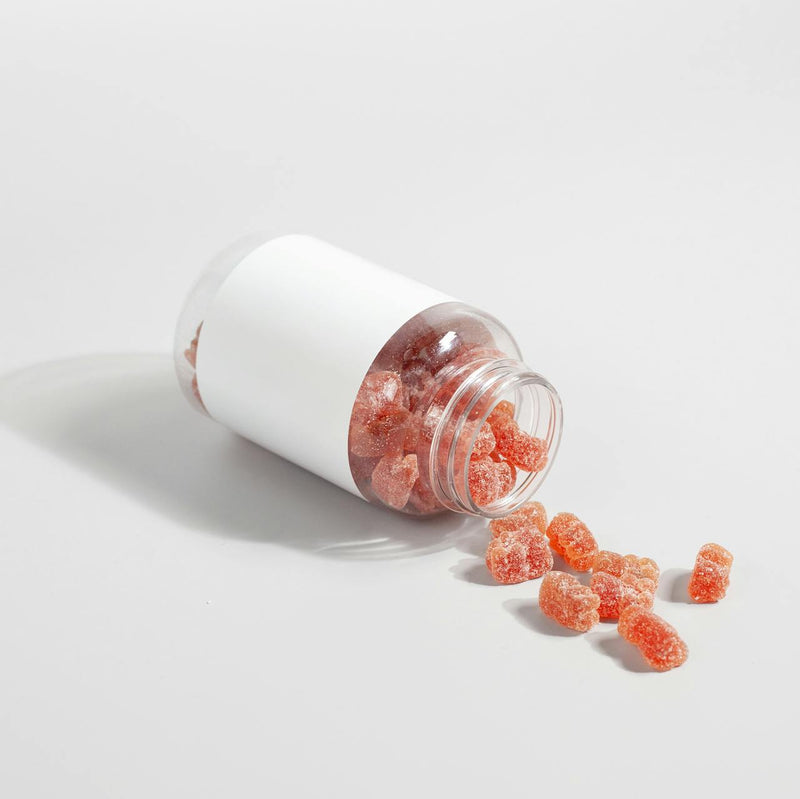 Supplement gummies on a white surface — magnesium glycinate gummies vs powder vs capsules