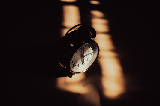 A clock on a bedside table at night, does magnesium glycinate make you sleepy