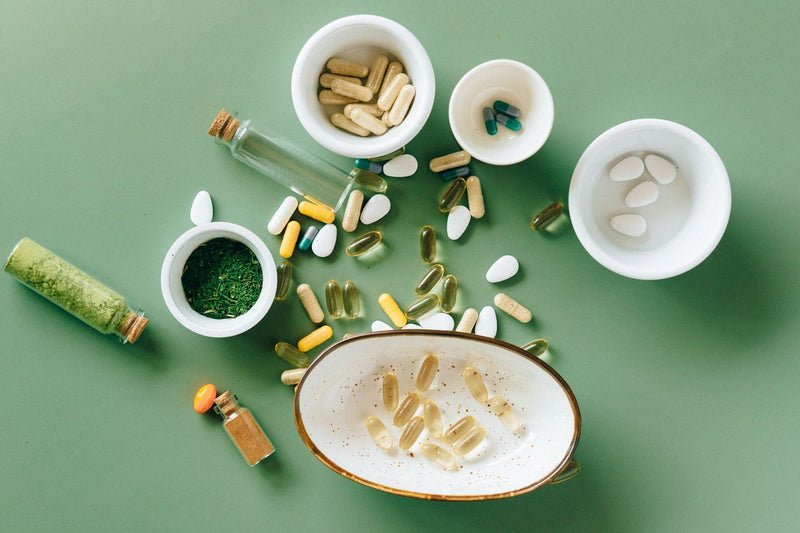 Daily wellness supplement capsules flat lay: sleep support and focus support